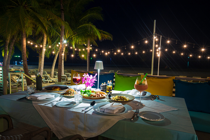 A romantic dinner by a Hawiian beach.