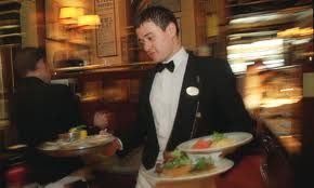 Talented waiter in a busy restaurant.